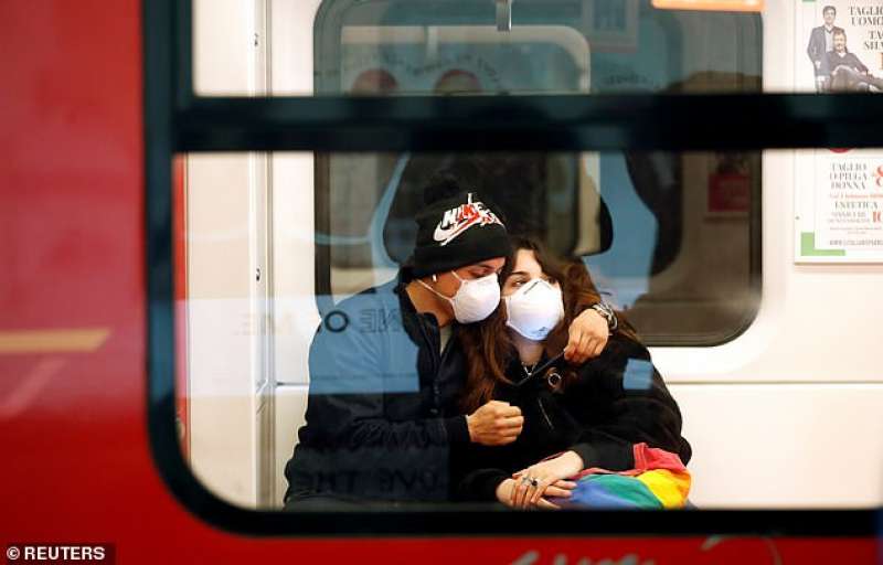 coppia con mascherina in metro a milano