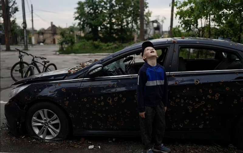 un bambino guarda un edificio distrutto durante gli attacchi nella periferia di irpin, kiev